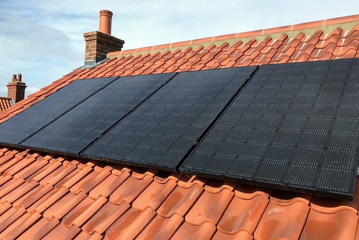 Solar Panels Standard Roof Tiles Black solar panels on a roof with orange tiles
