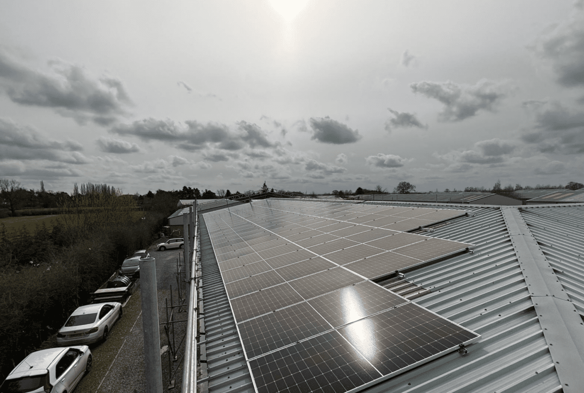 Black solar panels on a warehouse roof
