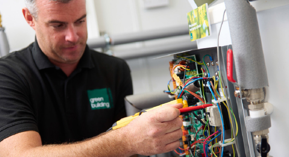 A Green Building Renewables installer working with wires
