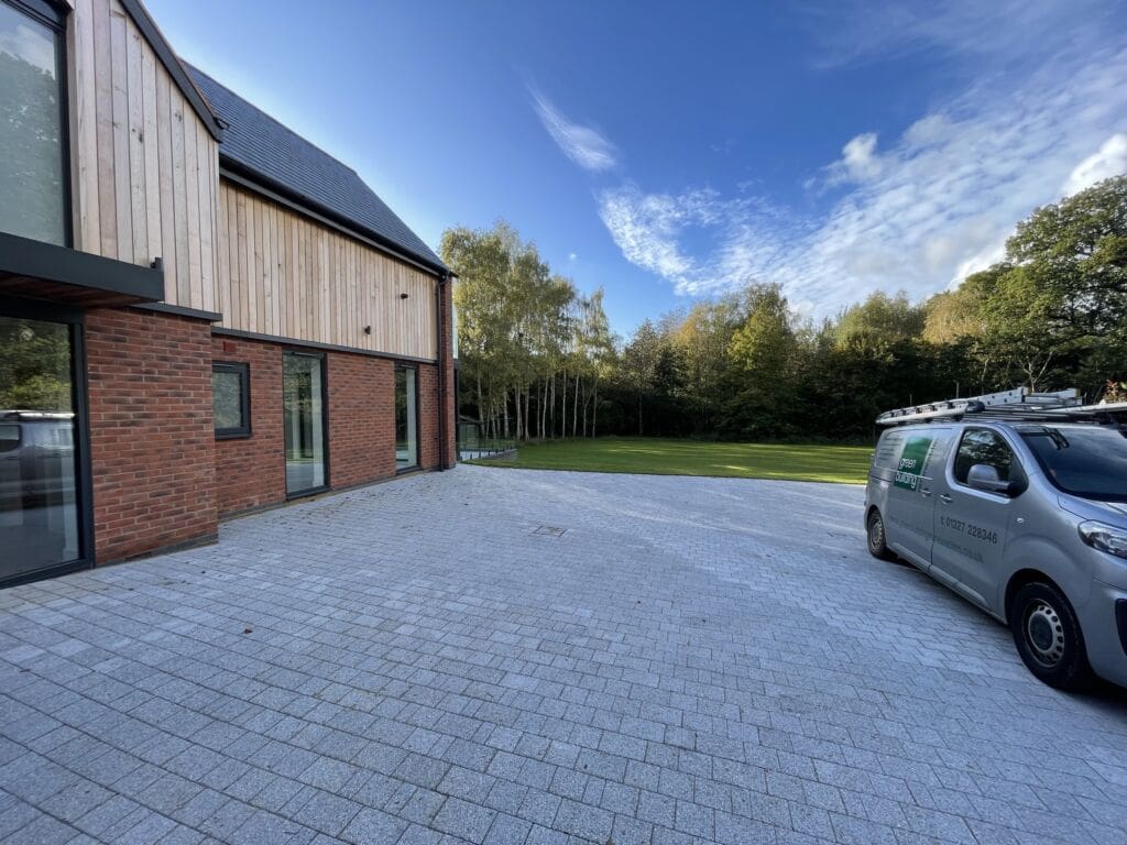 A grey driveway and garden, showing how tidy a GSHP installation can be