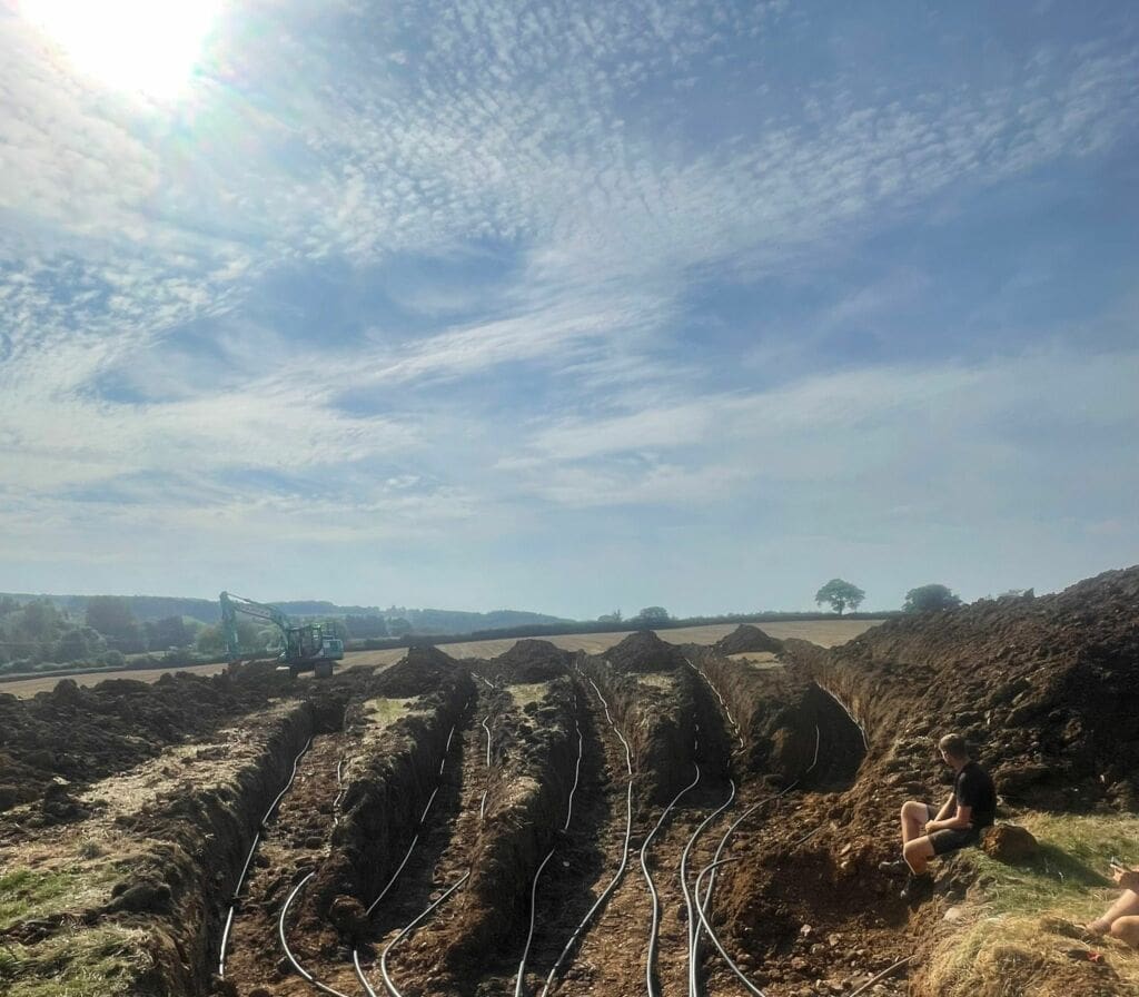 A field with pipes going in for a GSHP