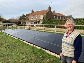 Janet and her ground-mounted solar installation